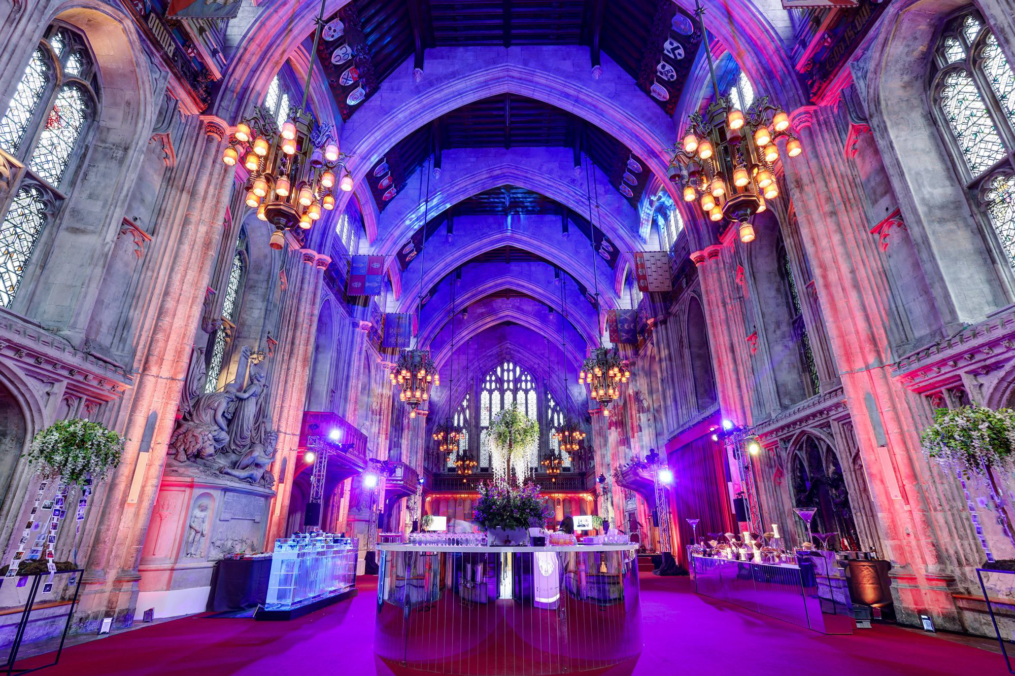 a view of the great hall with a drinks bar in the centre with pink lighing surrounding