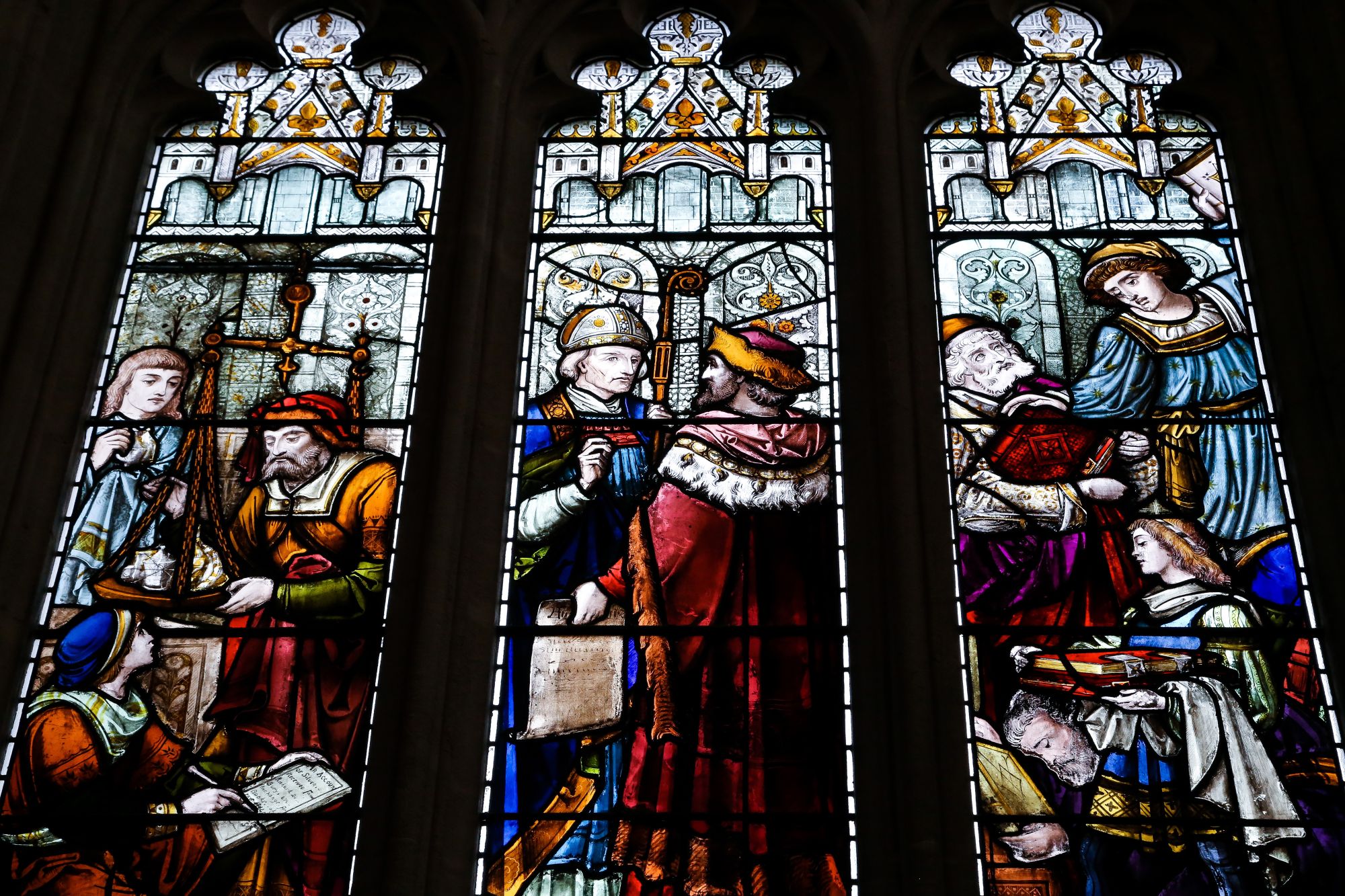 three stainglass windows showing images of different images in the old library